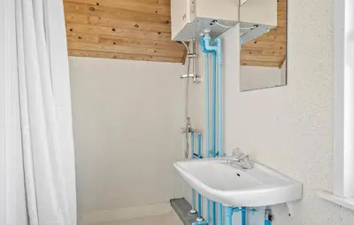 a bathroom with a sink and a shower at Four-Bedroom Holiday Home In Thyboron in Thyborøn