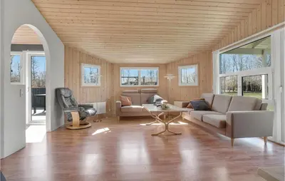 a living room with a couch and a table at Cozy Home In Roslev With Wifi in Roslev