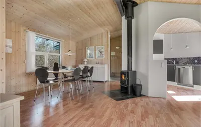 a kitchen and dining room with a table and chairs at Cozy Home In Roslev With Wifi in Roslev