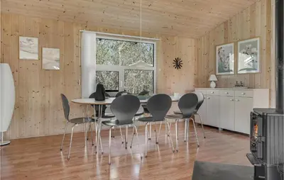 a dining room with a table and chairs at Cozy Home In Roslev With Wifi in Roslev