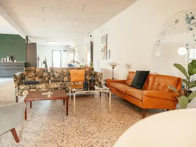 a living room with two couches and a table at Containerhus 18b in Harboør