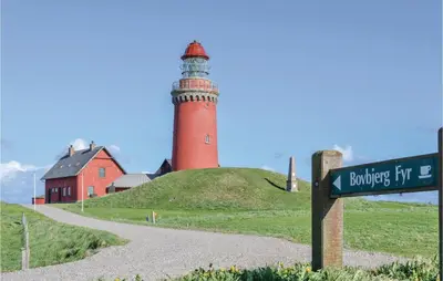 a lighthouse on top of a hill with a street sign at Two-Bedroom Apartment In Lemvig in Lemvig