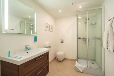a bathroom with a sink and a shower at Klitmøller Hotel in Klitmøller
