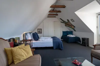 a attic room with a bed and a couch at Klitmøller Hotel in Klitmøller