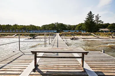 a wooden bridge over a river with a train at Danhostel Nykøbing Mors in Nykøbing Mors