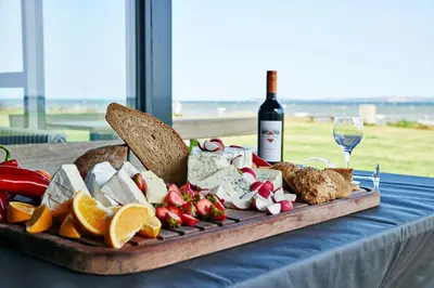 a tray of food on a table with a bottle of wine at Danhostel Nykøbing Mors in Nykøbing Mors