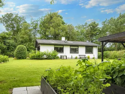 a white house with a garden in front of it at 5 person holiday home in Vinderup-By Traum in Vinderup