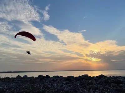 a person flying a kite over the water at 5 person holiday home in Vinderup-By Traum in Vinderup