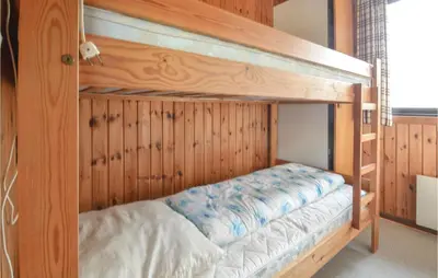 a bunk bed in a room with wooden walls at Three-Bedroom Holiday Home In Hurup Thy in Sindrup