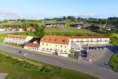 an aerial view of a village with a building at Hvalpsund Færgekro in Hvalpsund