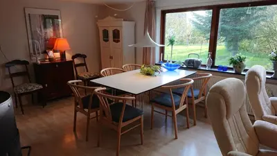 a kitchen with a dining room table and chairs at B&B Hesselbjerg in Hesselbjerg