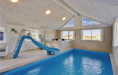 a indoor swimming pool with a slide in a house at 8 Bedroom Awesome Home In Thisted in Thisted