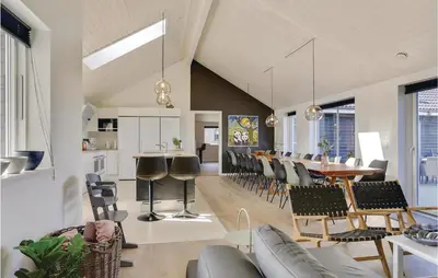 a kitchen and dining room with a table and chairs at 8 Bedroom Awesome Home In Thisted in Thisted