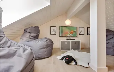 a room with two beds in a attic at 8 Bedroom Awesome Home In Thisted in Thisted