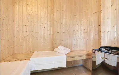 a sauna with two towels sitting on a bench at 8 Bedroom Awesome Home In Thisted in Thisted