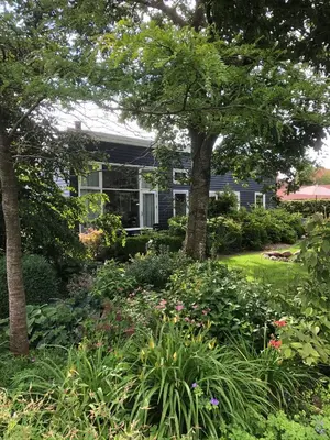a house with a garden with flowers and trees at Fly B&B in Skive
