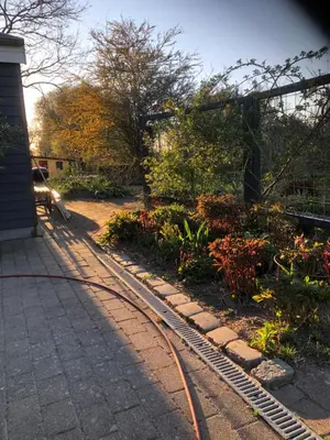 a garden with a train track and some flowers at Fly B&B in Skive
