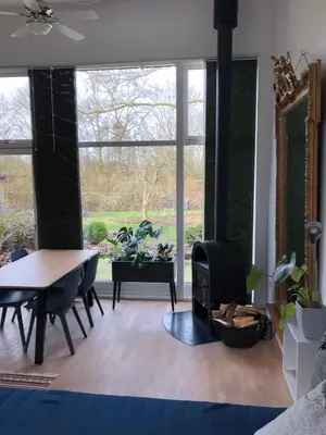 a living room with a table and a stove at Fly B&B in Skive