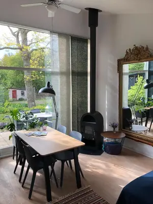 a dining room with a table and a fireplace at Fly B&B in Skive