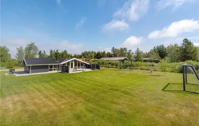 a house with a large yard with a goal at Four-Bedroom Holiday Home In Fjerritslev in Fjerritslev