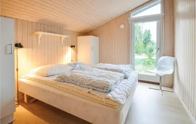 a bedroom with a bed in a room with a window at Four-Bedroom Holiday Home In Fjerritslev in Fjerritslev