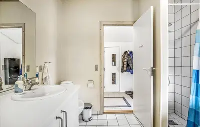 a white bathroom with a sink and a toilet at Four-Bedroom Holiday Home In Fjerritslev in Fjerritslev