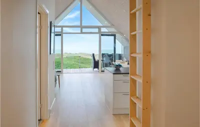 a kitchen with a view of the ocean from a house at Two-Bedroom Apartment In Thisted in Thisted