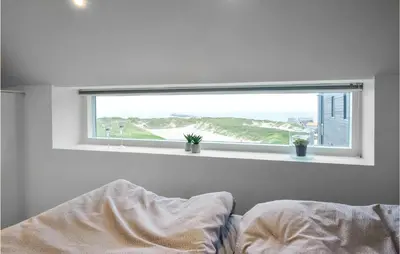 a window in a bedroom with a bed in front of it at Two-Bedroom Apartment In Thisted in Thisted