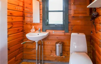 a bathroom with a toilet and a sink at Three-Bedroom Holiday Home In Roslev in Roslev