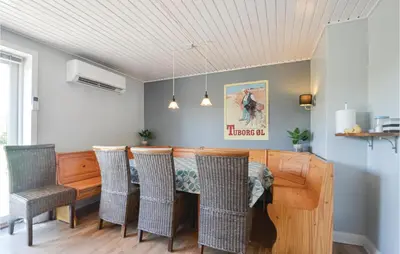 a dining room with a table and chairs at Three-Bedroom Holiday Home In Vinderup in Vinderup