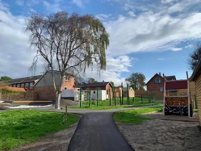 a walking path in a park with a tree at Feriehus Thy - I hjertet af Thy in Thisted