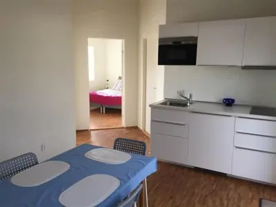 a kitchen with a table and chairs in a room at Bulbjerguld BB in Frøstrup