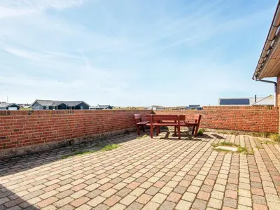 a picnic table sitting on a brick wall at 14 person holiday home in Harboøre in Harboør