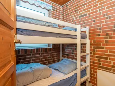 a room with two bunk beds in a brick wall at 14 person holiday home in Harboøre in Harboør