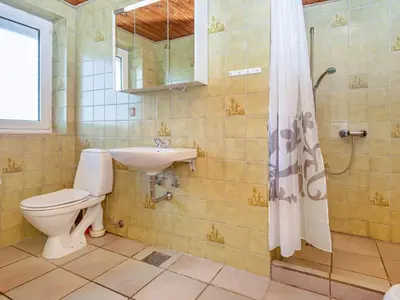 a bathroom with a toilet and a sink and a shower at 14 person holiday home in Harboøre in Harboør