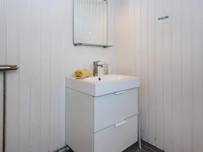a white bathroom with a sink and a mirror at 5 person holiday home in Lemvig in Lemvig