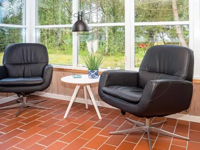 two black chairs and a table in a room at 6 person holiday home in Thisted-By Traum in Thisted