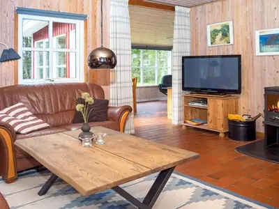 a living room with a couch and a table and a television at 6 person holiday home in Thisted-By Traum in Thisted