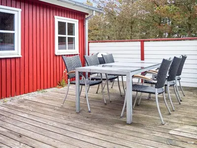 a table and chairs sitting on a deck at 6 person holiday home in Thisted-By Traum in Thisted