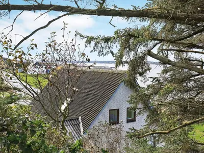 a house with a pitched roof and trees at Seaside Retreat in Hvalpsund-By Traum in Farsø