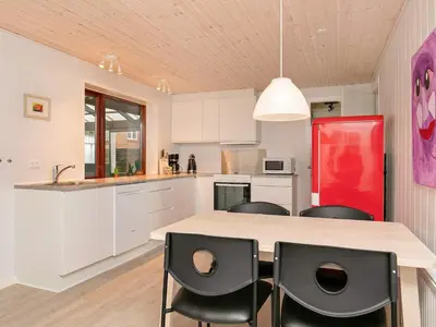 a kitchen with white cabinets and a red refrigerator at Seaside Retreat in Hvalpsund-By Traum in Farsø