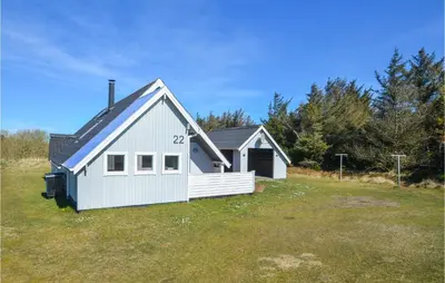 a small white house in a field of grass at 3 Bedroom Awesome Home In Thisted in Thisted