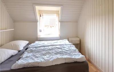 a bedroom with two beds and a window at 3 Bedroom Awesome Home In Thisted in Thisted