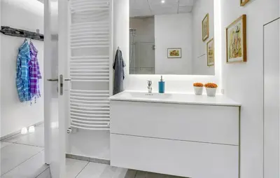 a white bathroom with a sink and a mirror at Amazing Home In Løgstrup With Wifi in Løgstrup