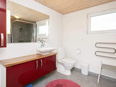 a bathroom with a toilet and a sink and a window at Cozy Coastal Retreat in Vorupor-By Traum in Thisted