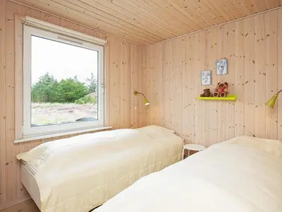 a bedroom with two beds and a window at Cozy Coastal Retreat in Vorupor-By Traum in Thisted