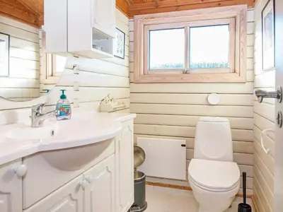 a white bathroom with a toilet and a sink at 6 person holiday home in Lemvig in Lemvig