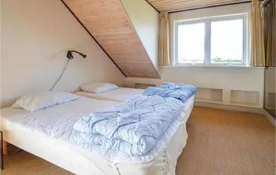 two twin beds in a room with a window at Lovely Home In Fur With Kitchen in Fur