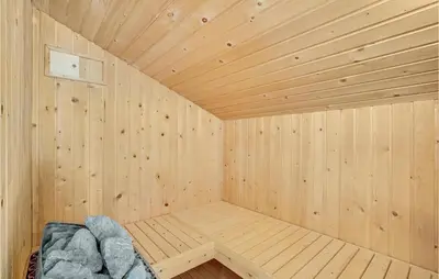 a wooden room with a sauna with a rock at Nice Home In Vestervig With Wifi in Vestervig