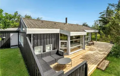 a house with a wooden deck with a patio at Nice Home In Vestervig With Wifi in Vestervig